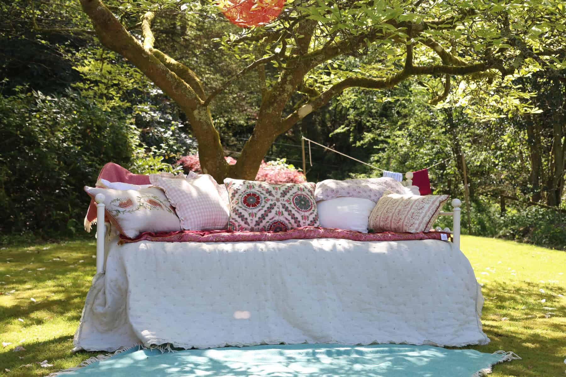 A beautiful daybed in an english cottage garden on a summers day